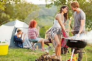 Male and female lovingly look each other while baked barbecue photo