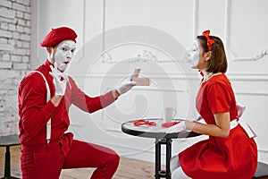 Male and female mime artists, scene with gift