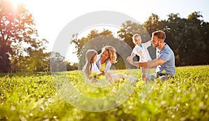 Male and female playing with children outside photo