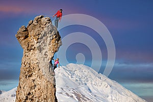 Male and female rock climbers with the lead that secures the partner