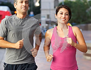 Male And Female Runners On Urban Street