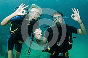 Male and female scuba dive together