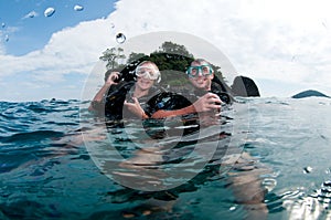 Male and female scuba dive together