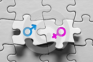 Male and female sex gender icons on connected jigsaw puzzle pieces. Unity, equality, togetherness, marriage or relationship