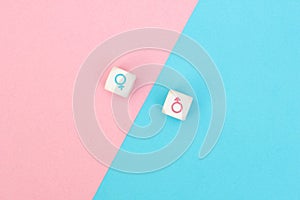 Male and female sex icons on cubes on pink and blue background. Sex change, gender reassignment, transgender and sexual identity
