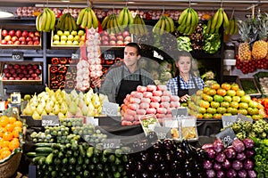 Two sellers laying out vegetables photo