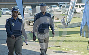 A Male and female South African traffic police officers waering protective vests