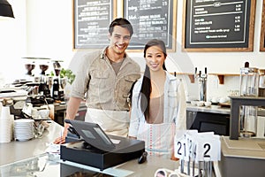 Male And Female Staff In Coffee Shop