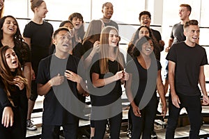 Male And Female Students Singing In Choir At Performing Arts School