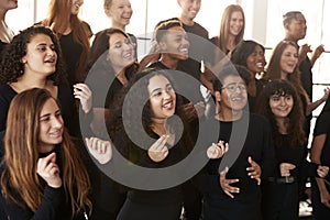 Male And Female Students Singing In Choir At Performing Arts School photo