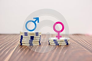 Male and female symbols on piles of coins