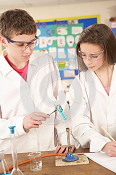 Male And Female Teenage Student In Science Class