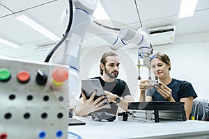 Male and female using tablet staff engineer with robot for education at class room. Education for future robotics learning