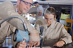 Male and female workers in garage