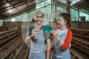 Male and female workers holding cell phone and passbook