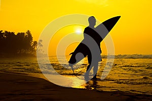 The male figure with a board for surf on a background of ocean w