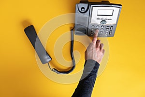 Male finger dialing a telephone number