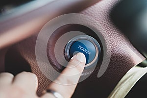 Male finger pressing the engine start button in the car. Start and stop button