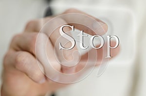 Male finger touching Stop button on a virtual screen photo