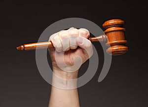 Male Fist Holding Wooden Gavel