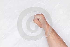 Male fist on the white background table with copy space
