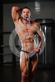 Male Fitness Competitor Showing His Winning Medal