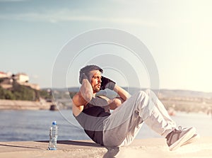 Male fitness model doing sit ups and crunches exercising abdominal muscles