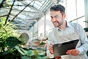 male florist taking notes on the clipboard.