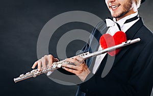 Male flutist with flute and heart. Love melody