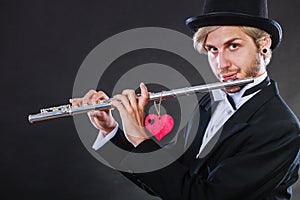 Male flutist with flute and heart. Love melody