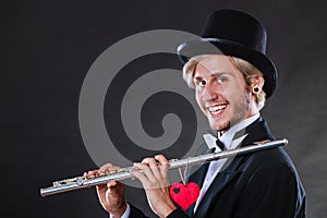 Male flutist with flute and heart. Love melody