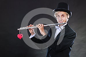 Male flutist with flute and heart. Love melody