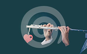 Male flutist with flute and heart. Love melody