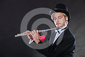 Male flutist with flute and heart. Love melody