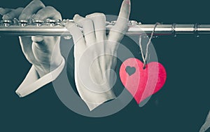 Male flutist with flute and heart. Love melody