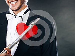 Male flutist with flute and heart. Love melody