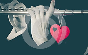 Male flutist with flute and heart. Love melody photo