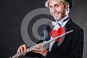 Male flutist with flute and heart. Love melody