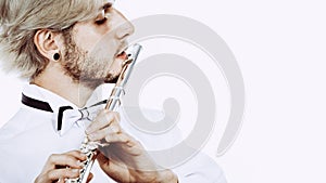 Male flutist playing his flute