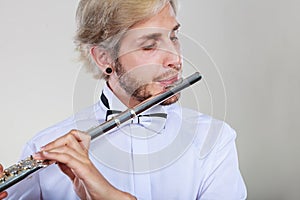 Male flutist playing his flute