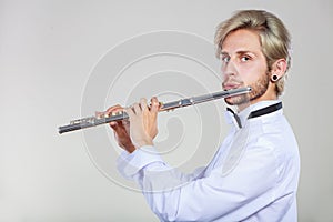 Male flutist playing his flute