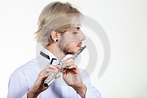 Male flutist playing his flute