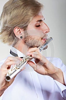 Male flutist playing his flute