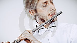 Male flutist playing his flute