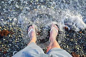 Male foots in shales in transparent sea water