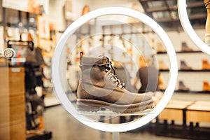 Male footwear selling. Formal leather shoes at shelf in shop window