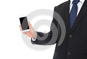 Male in formalwear standing in front of white background holding mobile phone in hand