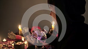 Male fortune teller performing ritual with crystal ball foreseeing future