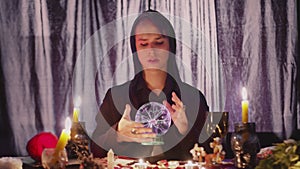 Male fortune teller performing ritual with crystal ball foreseeing future