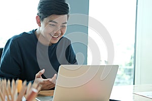 Male freelancer working with computer. startup man analyzing financial performance. student studying doing assignment photo